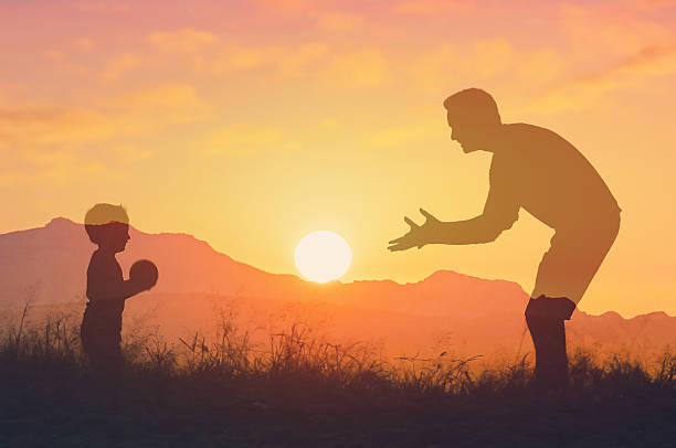 istock Father and son playing with ball outdoors. 2219389490