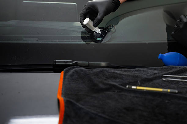 istock Resin Injection on Windshield. Windshield resin injection seals fractures and prevents spreading. UV resin fills cracks and cures into a crystal-clear finish. 2219389594