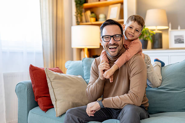 istock Cheerful father and son enjoy a playful bond filled with laughter. 2219390380