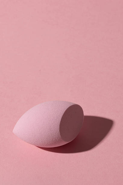 istock Makeup beauty blender sponge on pink background with shadow, copy space 2219390425