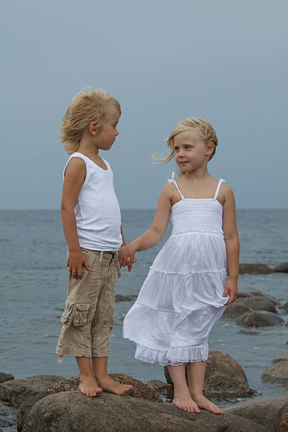 Little girl and boy outdoors portrait.
