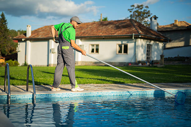 istock Swimming pools maintainer cleaning out one at a private home. 2219391399