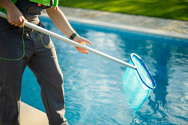 istock Swimming pools maintainer cleaning out one at a private home. 2219391404