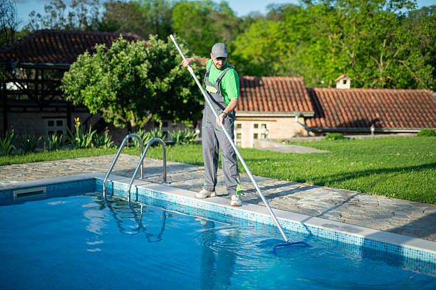 istock Swimming pools maintainer cleaning out one at a private home. 2219391409