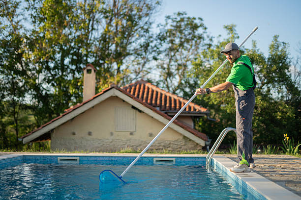 istock Swimming pools maintainer cleaning out one at a private home. 2219391410