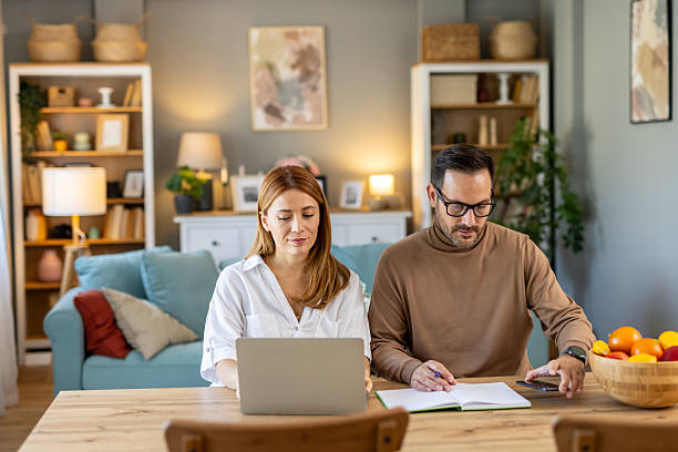 istock Couple working together on finances at their home kitchen table. 2219392561