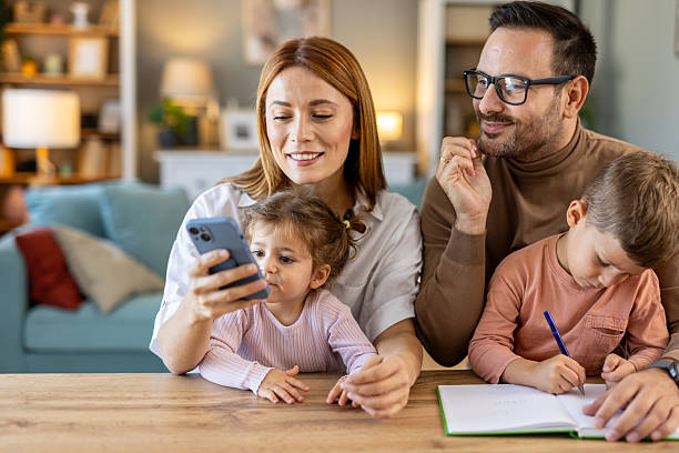 Family engaged in bonding time with technology in their home