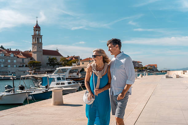 istock Mature Couple Strolling in Coastal Sutivan 2219392603