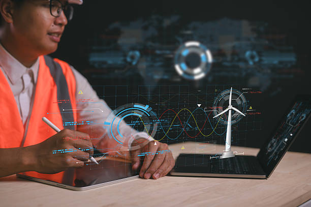 istock Reduce CO2 emissions and carbon footprint to limit global warming and climate change. Sustainable development and green business, Engineer working with diagram of sustainable energy wind turbine 2219394921