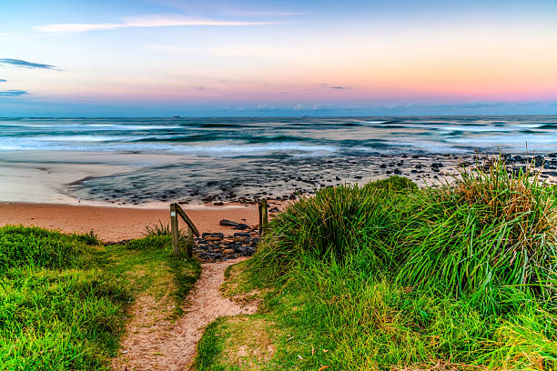 istock Sunset at the Seaside with black rocks 2219395179