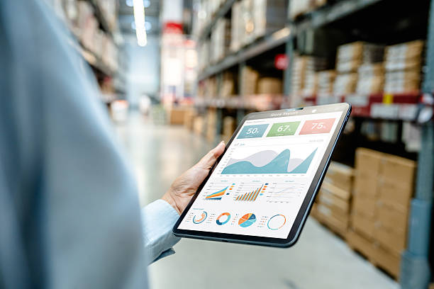 istock Warehouse employee using digital tablet to monitor business analytics dashboard in modern storage facility for real-time inventory tracking, logistics management, and operational performance. 2219397385