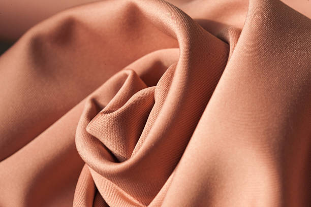 istock Processed collage of smooth elegant wavy dusty rosa polyester thick cloth fabric named neoprene used for casual and sporty clothing. 2219399062
