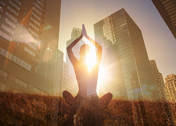 istock Woman meditating on city background. 2219399774