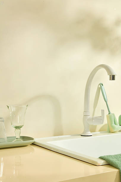 istock A bright kitchen scene featuring a faucet and cloths folded on the side, suggesting preparation for dishwashing and household cleaning tasks. Lifestyle concept photography for cleaning products 2219403812