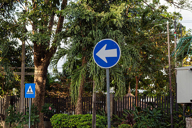 istock Blue Left Turn Traffic Sign in Urban Setting 2219404484