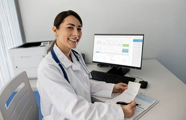 istock Happy doctor smiling while working in her office 2219405126