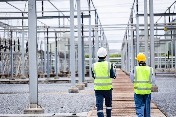 istock Engineer is working at high voltage power substation performing inspection and check of infrastructure to ensure safety and proper operation of electrical system 2219405320