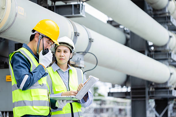 istock Engineer is working at high voltage power substation performing inspection and check of infrastructure to ensure safety and proper operation of equipment 2219405353