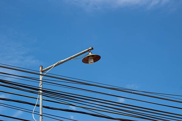 Electricity Network and Lighting Against Sky Background