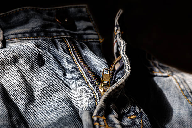 istock Broken Zipper on Denim Jeans Close-Up in Harsh Lighting 2219409845