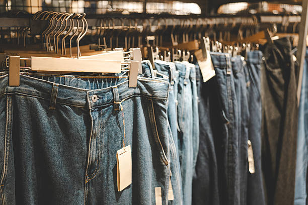 istock Hanging Blue Denim Jeans in Retail Store. the consumer perspective during shopping. making this a useful for advertising, branding, or retail marketing. 2219410155
