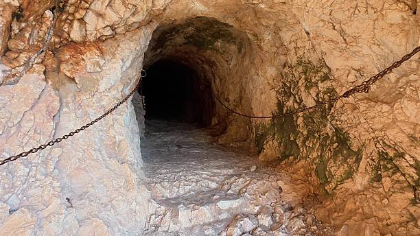 istock Embarking on a thrilling adventure to explore an Ancient Underground Tunnel adorned with Chains 2219410565