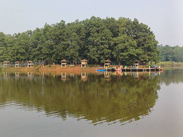 istock Tranquil Lakeside Retreat with Wooden Huts 2219410772