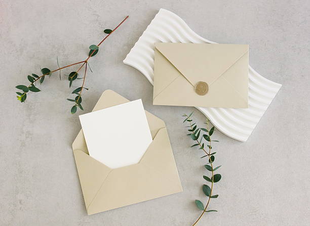 istock Beige envelope with blank paper card mockup  inside top view decor and eucalyptus leaves on beige textured background. 2219414964