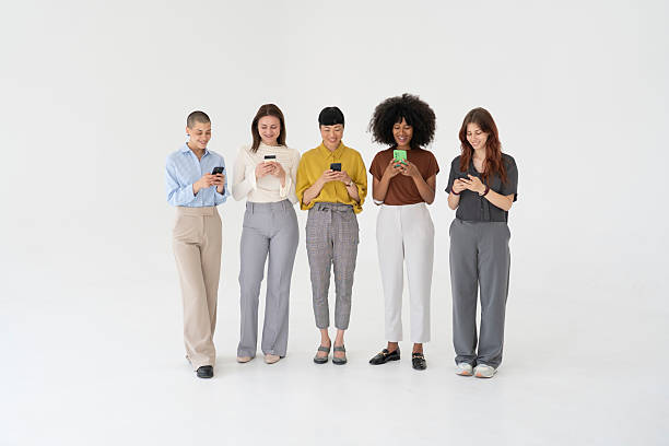 istock Five businesswomen using smartphones on white background 2219417435