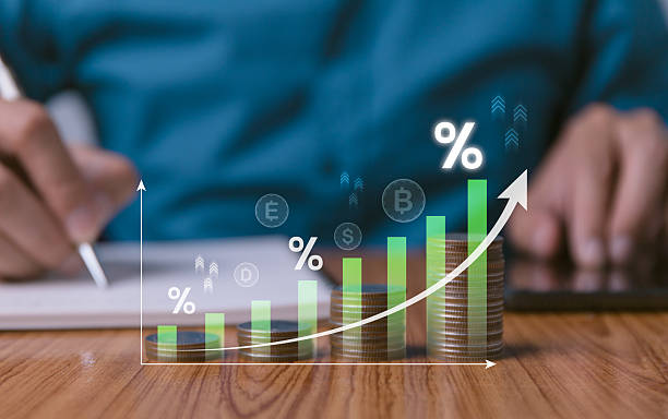 istock Financial growth chart with stacked coins and percentage symbols, person analyzing data. Investment increase, interest rates, economic progress, and business success. Finance and banking concepts. 2219417834