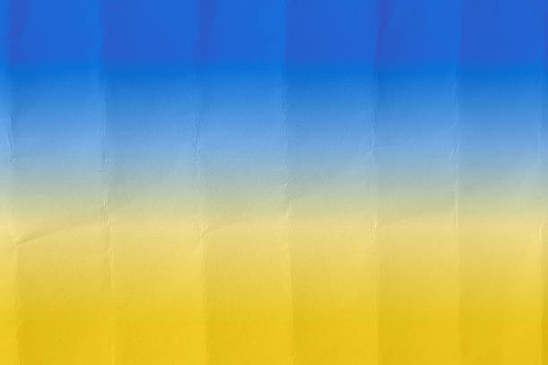 istock Colorful bright vibrant yellow and blue divided halved smudged painted vector background on folded crumpled paper as in Ukraine National flag full frame 2219418369