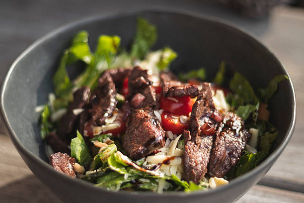 istock Delicious Steak Salad in a Dark Bowl 2219419485