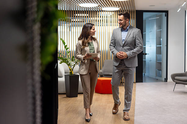 istock Businesspeople walking and talking in modern office 2219420765