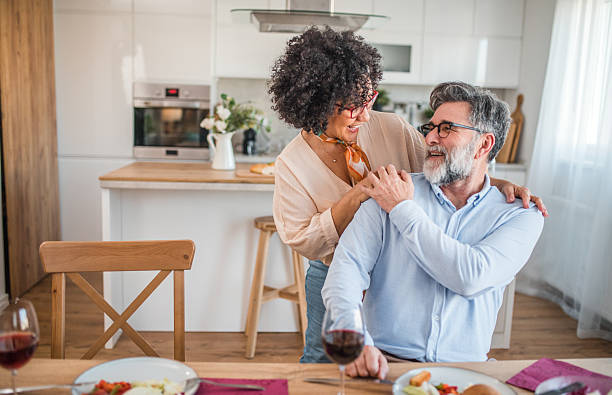 istock A black woman and her husband look at each other lovingly while having lunch at the dining room table 2219420986