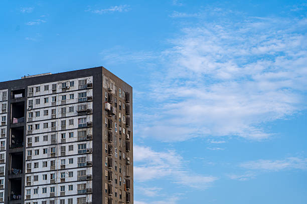 istock Modern Residential Apartment Building Against a Clear Blue Sky 2219421632