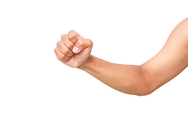 Close-up of a man's arm flexing with clenched fist against a plain white background