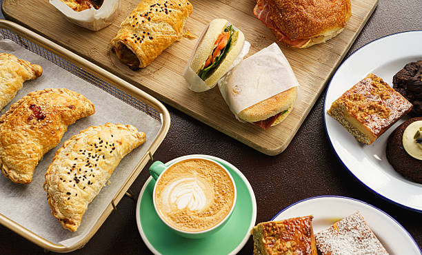A cozy spread featuring flaky pastries, savory sandwiches, burgers and a beautifully crafted latte- perfect for slow morning or mid-day treat.