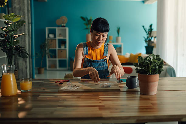 istock Asian craftswoman creating handmade jewelry in her workshop 2219430903