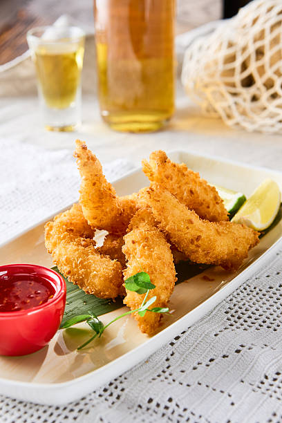 istock Tempura shrimp with sweet chili sauce on bright table, overhead composition 2219432829