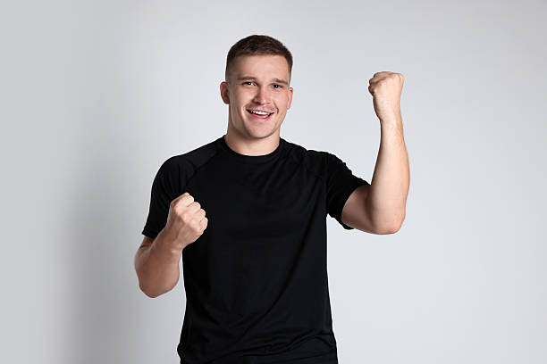istock Portrait of happy winner on light grey background 2219433178