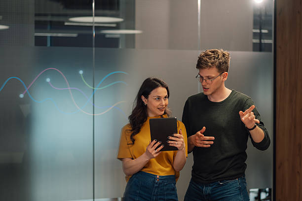 istock Business colleagues discussing data analysis on tablet in modern office 2219434704