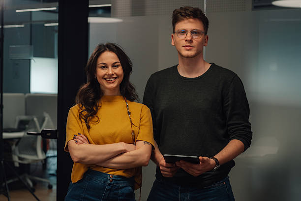 istock Two young professionals smiling confidently in modern office 2219434799