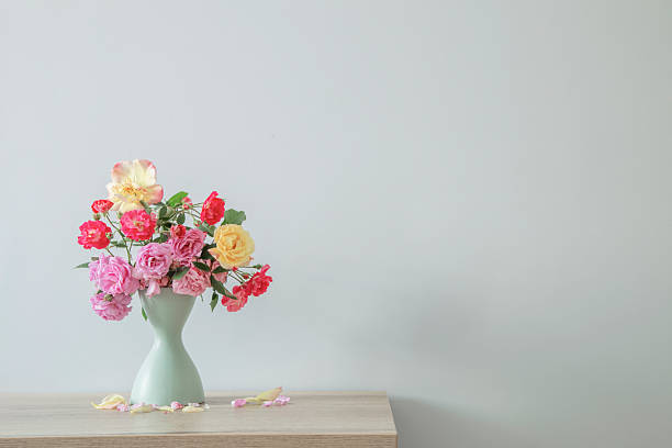 istock multicolored bouquet of roses on background white wall 2219434867