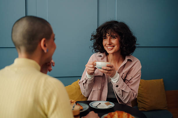 istock Two young women talking and having coffee at a cafe 2219435533