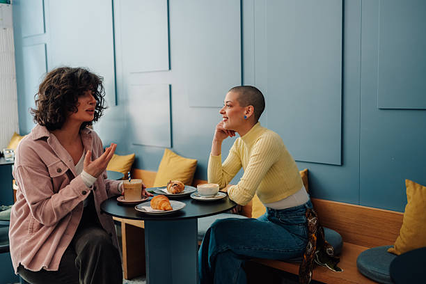 istock Two young women talking and having breakfast in a modern cafe 2219435553