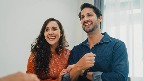 istock Financial advisor using digital tablet discussing about life insurance and domestic finances with young couple in living room at home. Financial planning and lifestyles concept. 2219440314