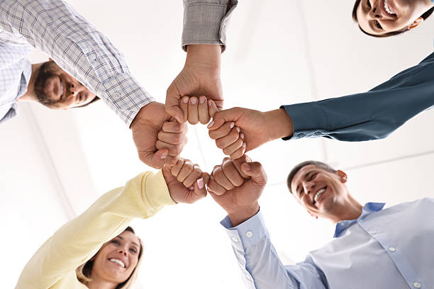 istock Teamwork. Group of employees joining hands in office, bottom view 2219441490