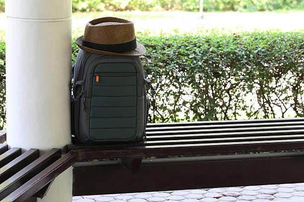 Woven hat and camera bag in the park