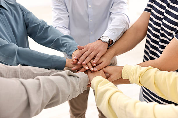 istock Teamwork. Group of employees joining hands in office, closeup 2219441845