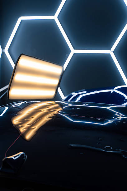 istock PDR lights reveal damage for accurate dent detection and assessment. Car panel shows multiple dents under PDR lighting, used in paintless dent repair to expose imperfections. 2219442434